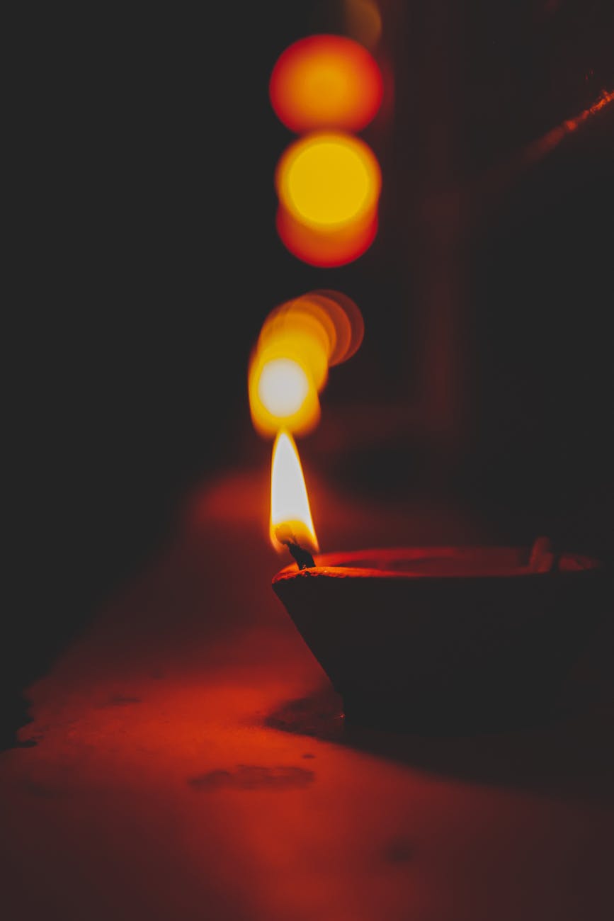 diya lamp burning on table at night