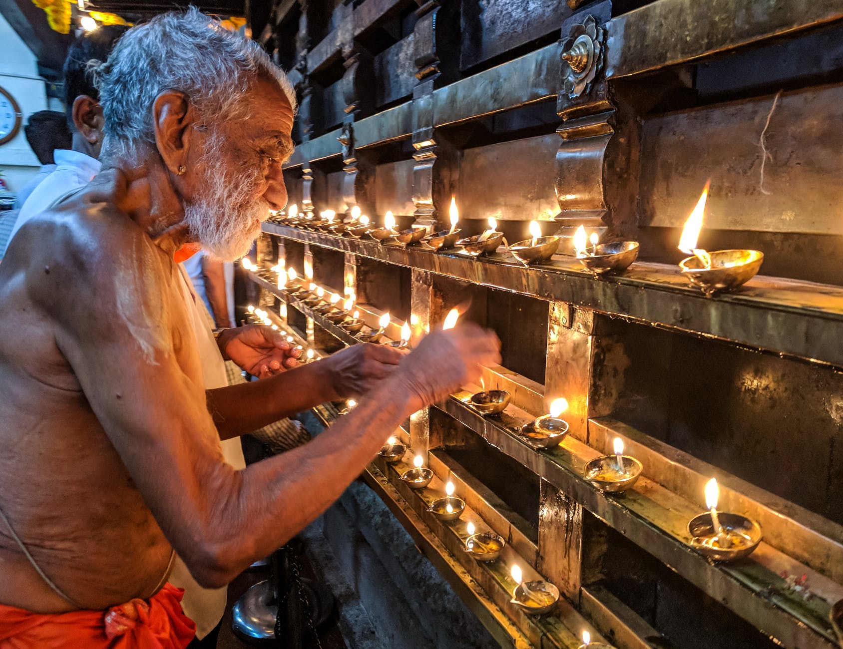 man lighting candles