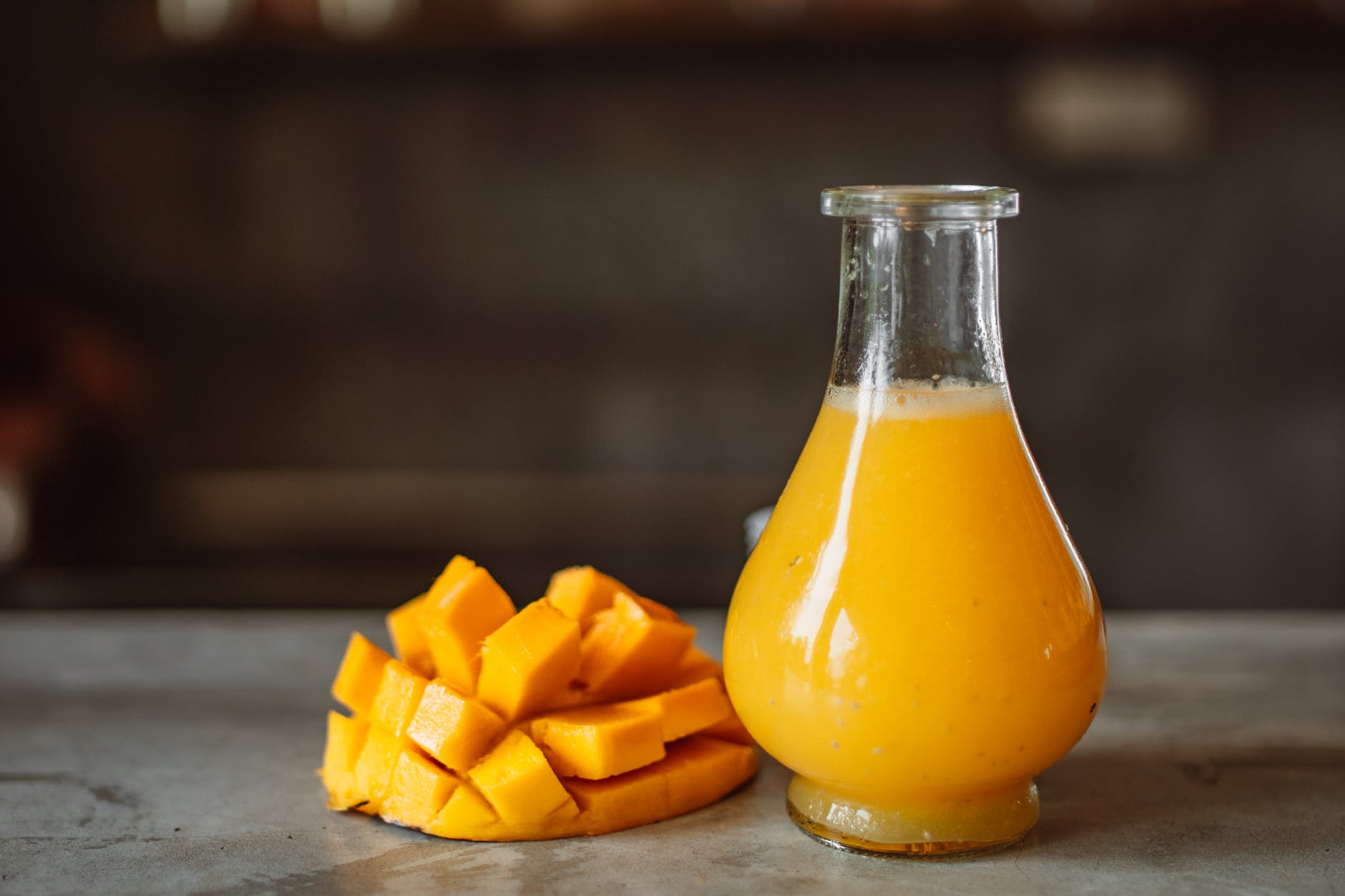 mango juice in clear glass bottle