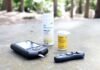 black smartphone beside white plastic bottle and black smartphone